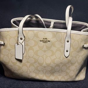 Authentic coach tan tote style bag with side draw string detail.